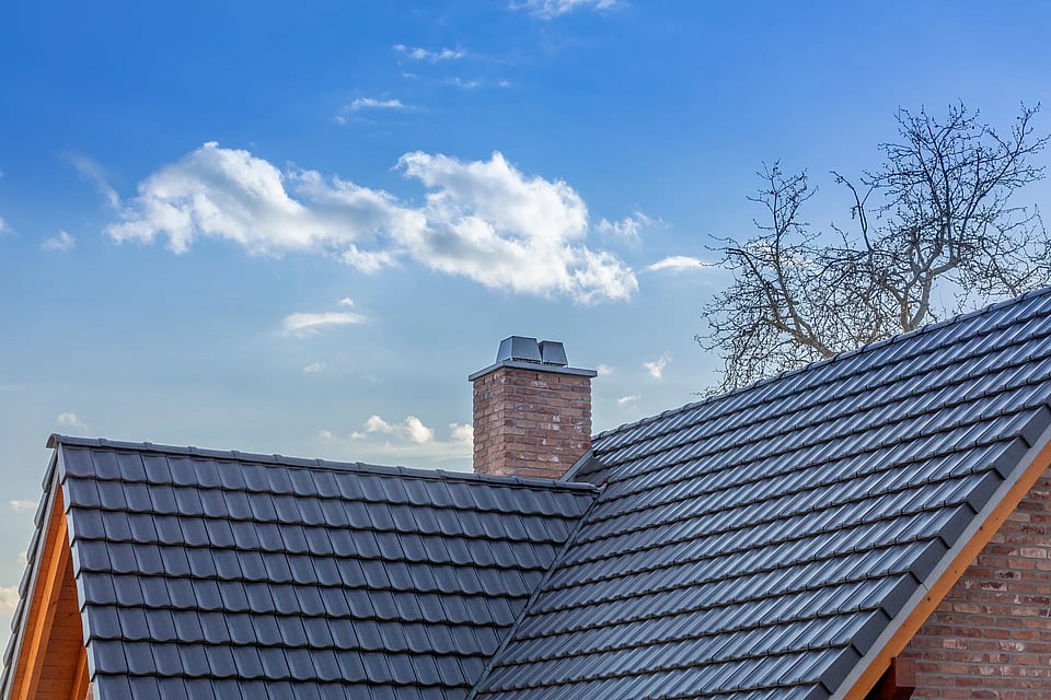 Adobe Stock image of a rooftop with a nice masonry chimney coming out of the top.