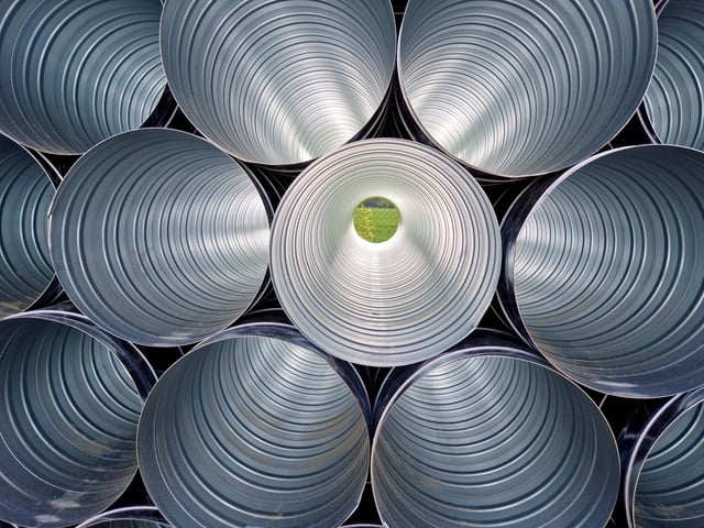 Adobe Stock image of chimney liners in a pile.