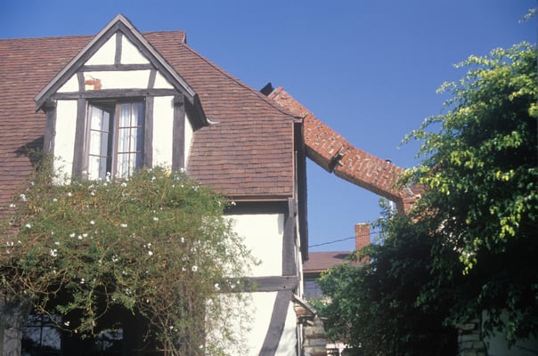 Brick chimney that has collapsed on a house