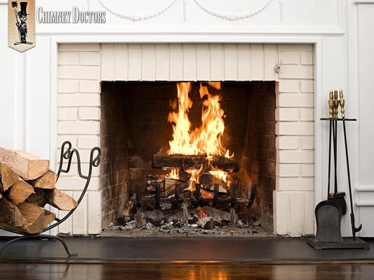 Fire blazing in a white brick fireplace